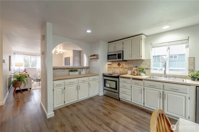a kitchen with sink cabinets and wooden floor