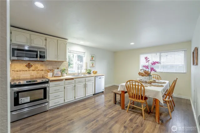 a dining room with furniture and wooden floor