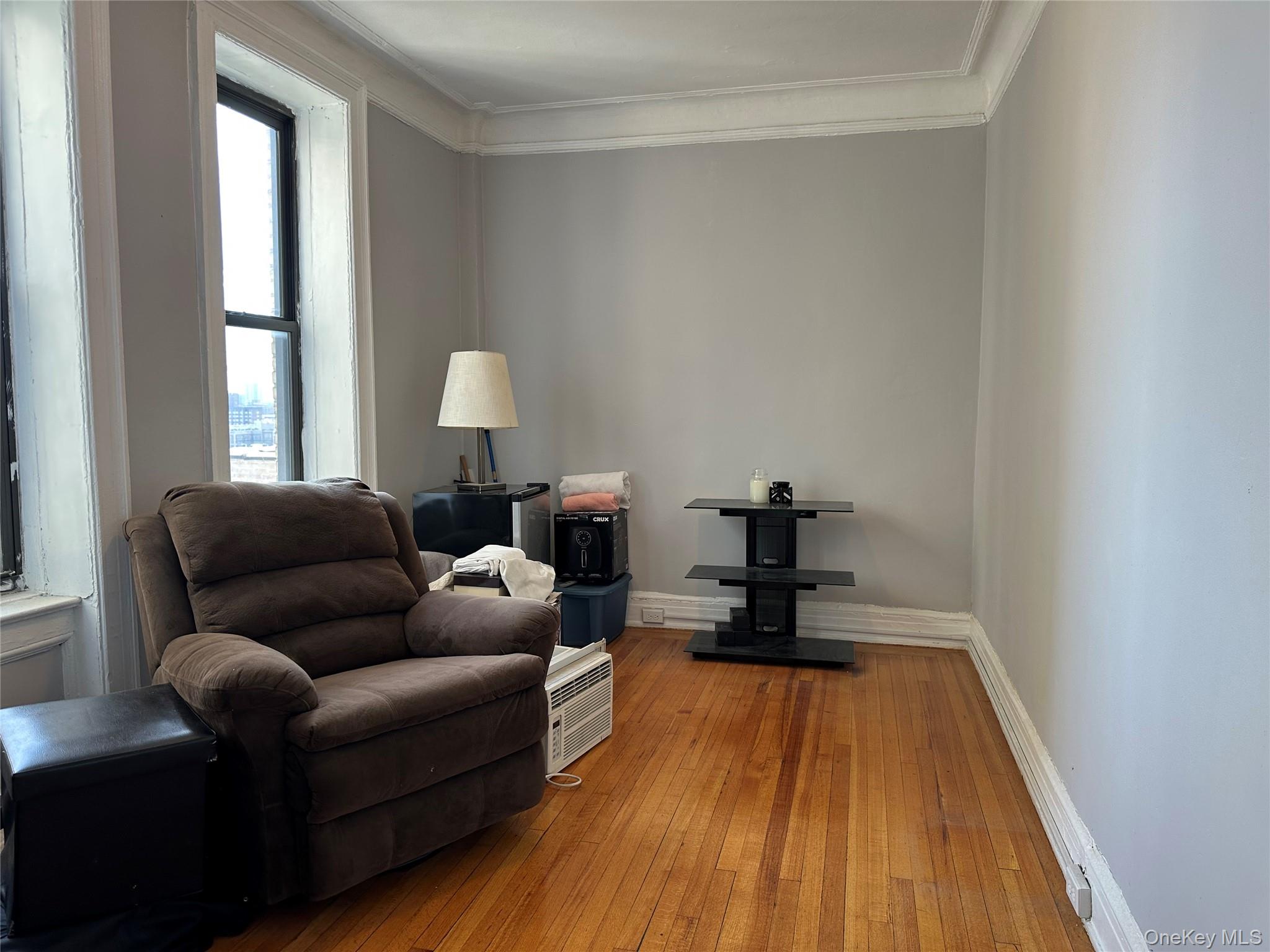 409 Edgecombe Avenue, Unit 7F Manhattan, NY 10032 - Photo 11 of 22 a living room with furniture and a wooden floor