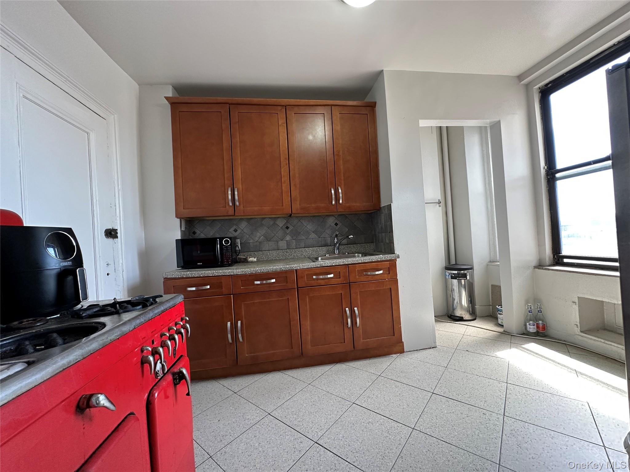 409 Edgecombe Avenue, Unit 7F Manhattan, NY 10032 - Photo 14 of 22 a kitchen with stainless steel appliances granite countertop a stove a sink and a microwave