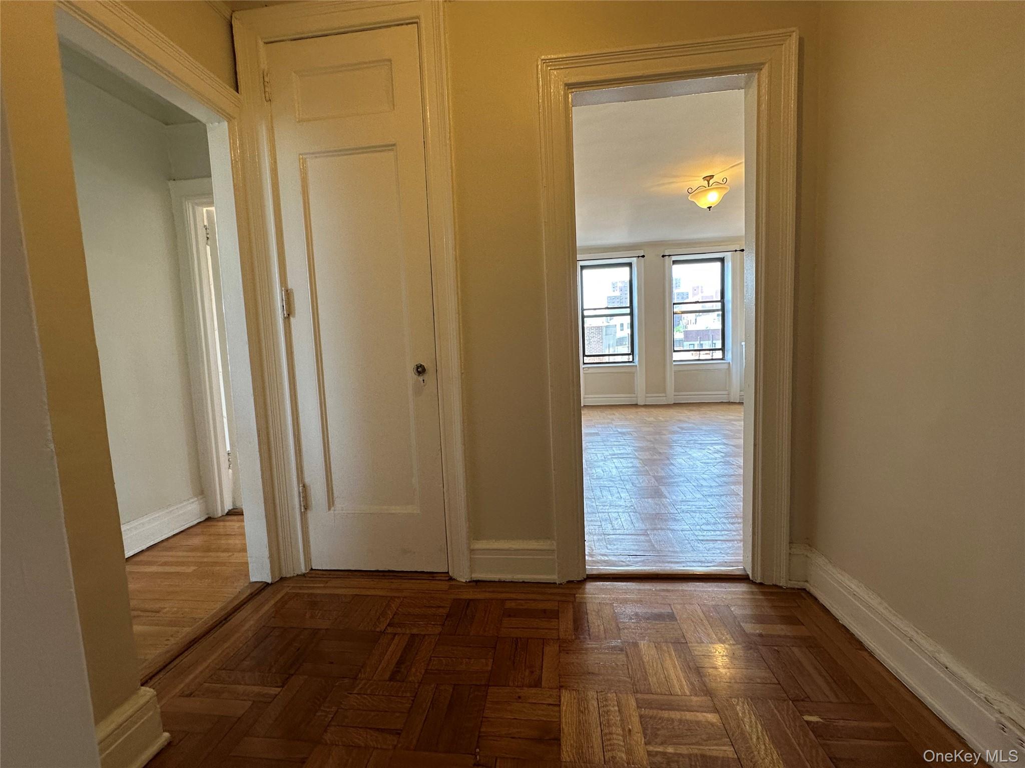 409 Edgecombe Avenue, Unit 7F Manhattan, NY 10032 - Photo 17 of 22 a view of an empty room with wooden floor and a window