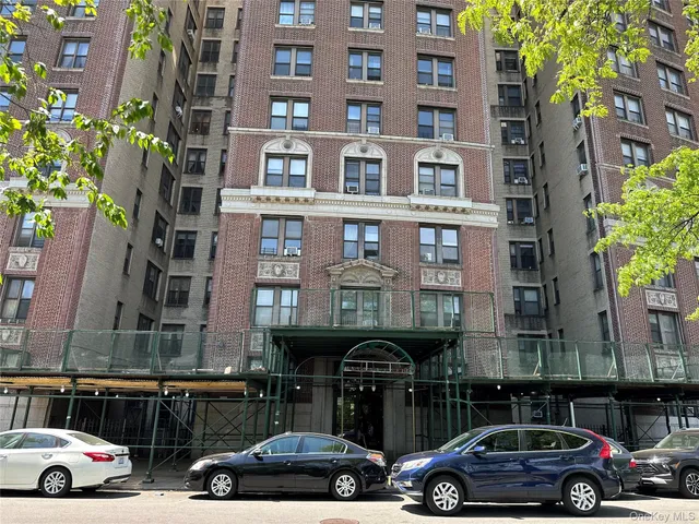 a couple of cars parked in front of a building