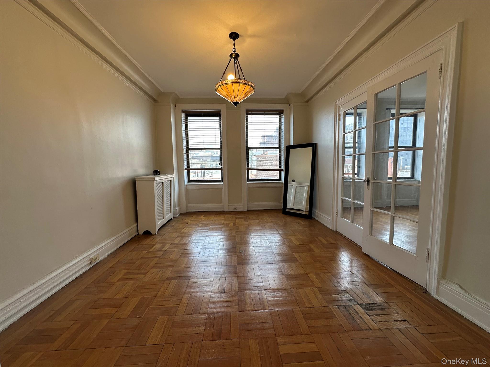 409 Edgecombe Avenue, Unit 7F Manhattan, NY 10032 - Photo 7 of 22 a view of an empty room with window and wooden floor