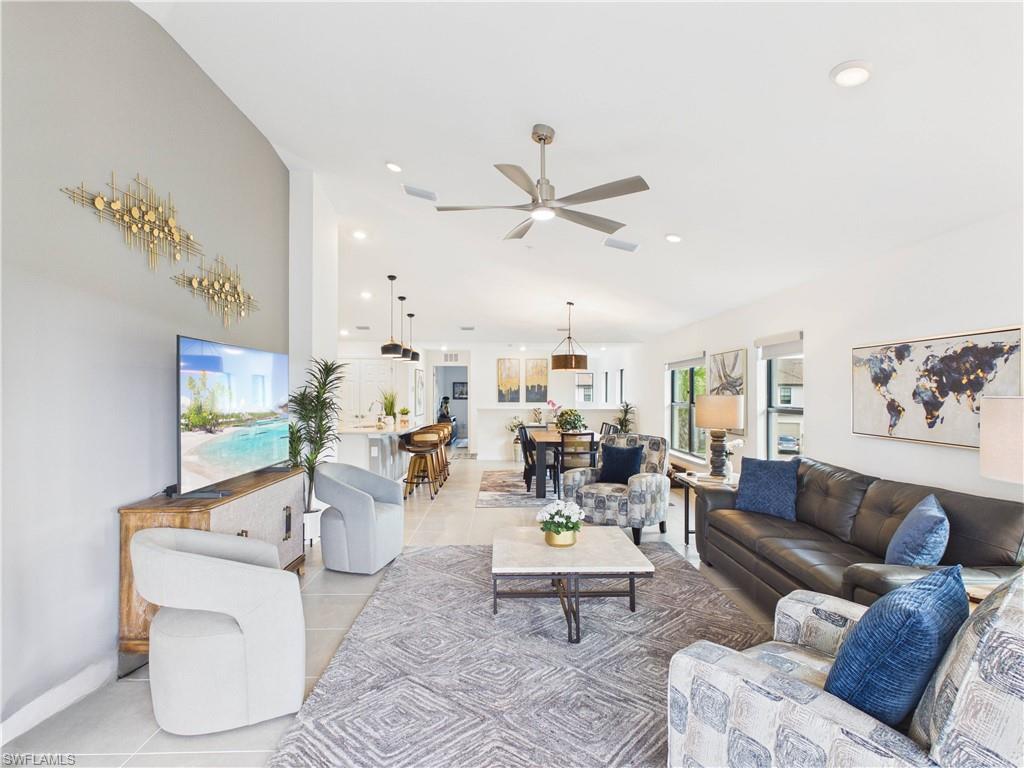 5683 Mayflower Way, Unit 908 Ave Maria, FL 34142 - Photo 21 of 37 Living room featuring ceiling fan, light tile patterned floors, recessed lighting, and vaulted ceiling