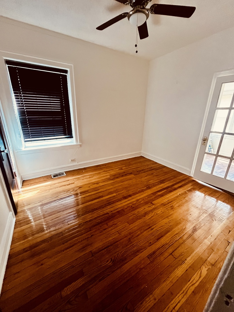 8236 South Sangamon Street, Unit 1 Chicago, IL 60620 - Photo 1 of 12 a view of empty room with window and wooden floor