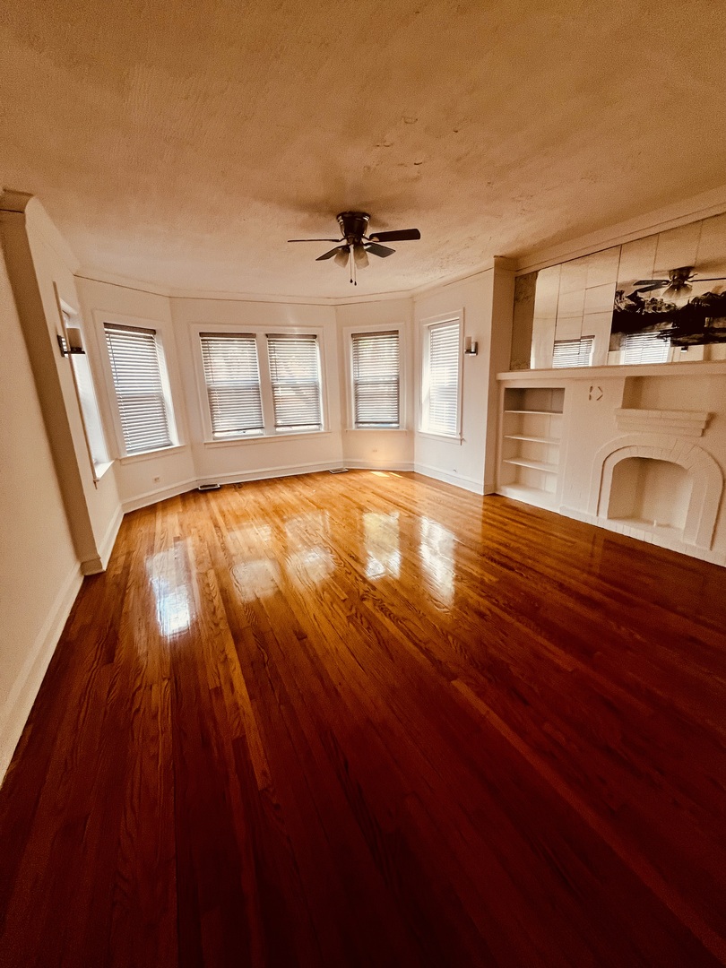 8236 South Sangamon Street, Unit 1 Chicago, IL 60620 - Photo 4 of 12 a view of an empty room with window and wooden floor