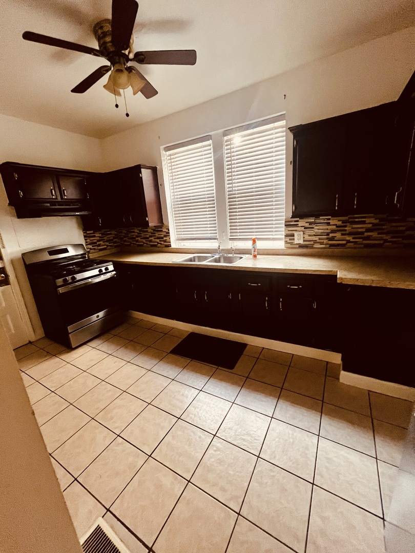8236 South Sangamon Street, Unit 1 Chicago, IL 60620 - Photo 7 of 12 a kitchen with a sink and a stove top oven