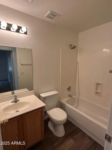a bathroom with a sink toilet vanity and shower