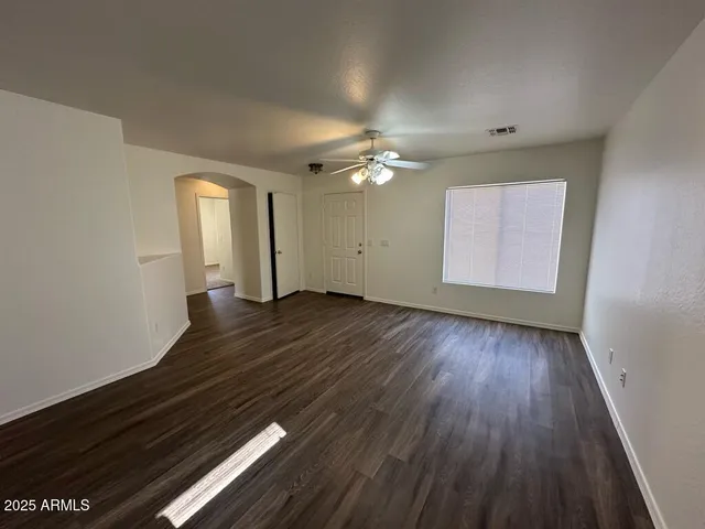 wooden floor in an empty room with a window