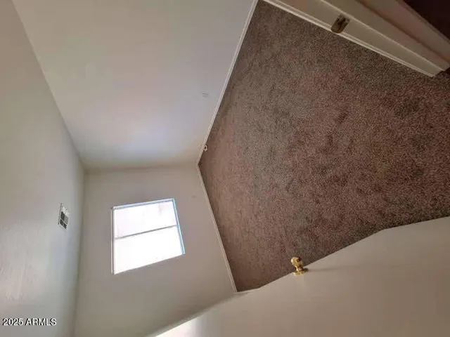 an empty room with closet and wooden floor