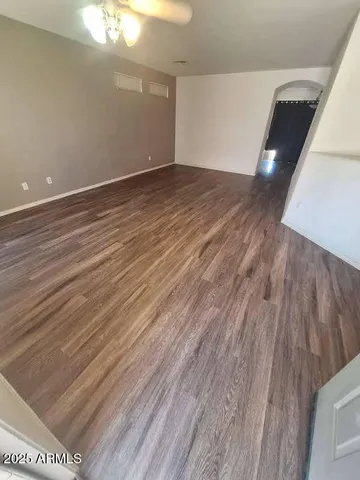 a view of an empty room and wooden floor