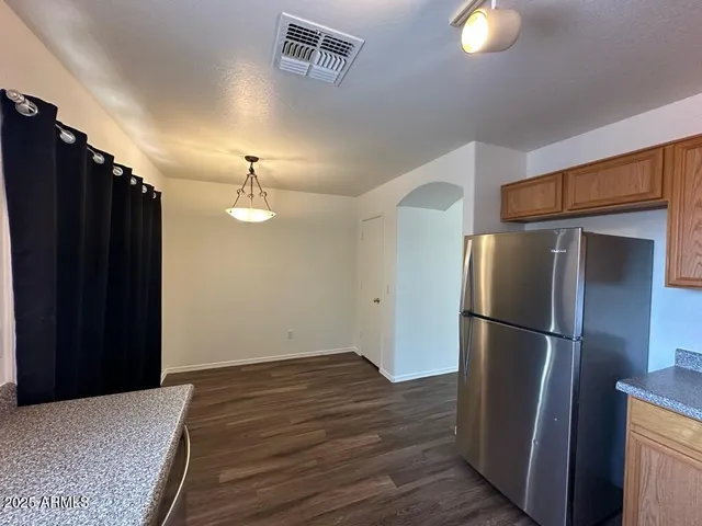 a kitchen with a refrigerator and cabinets