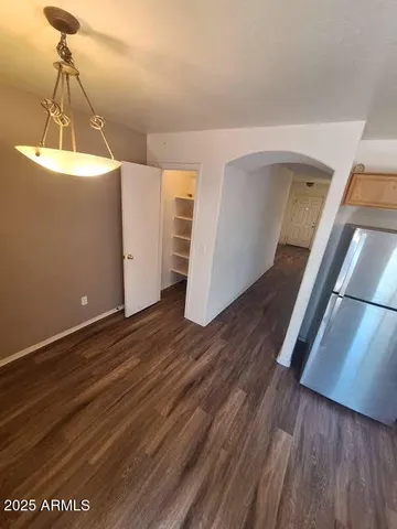 a view of a room with wooden floor