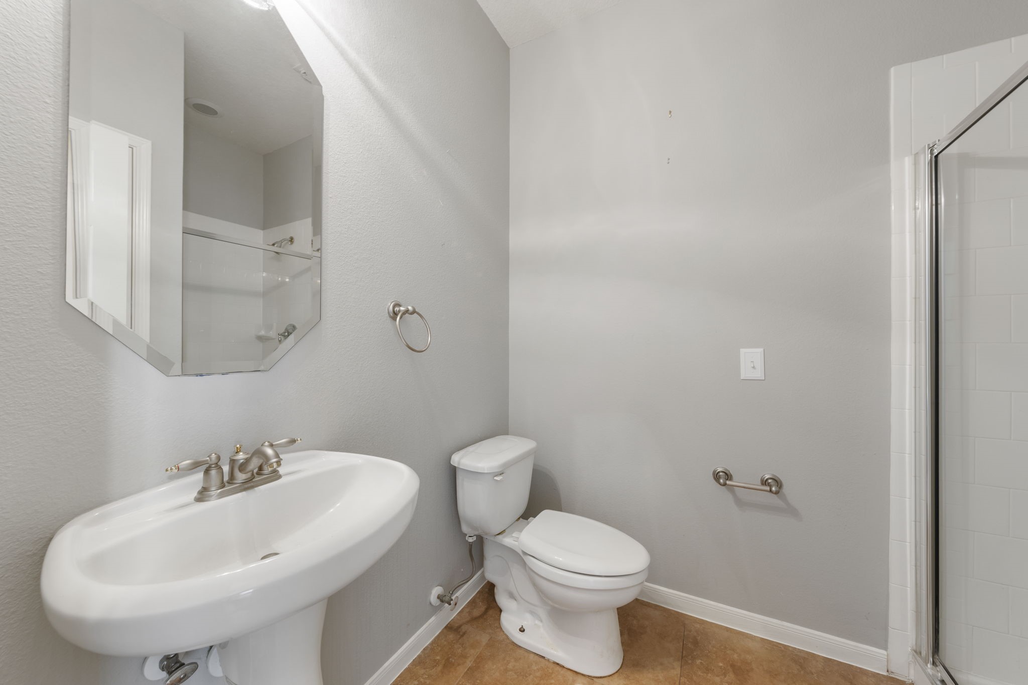 2907 Stemwood Drive Spring, TX 77388 - Photo 18 of 33 First-floor guest bath with pedestal sink, walk-in shower, and neutral finishes—perfectly positioned for guests with convenient access from the main living areas.