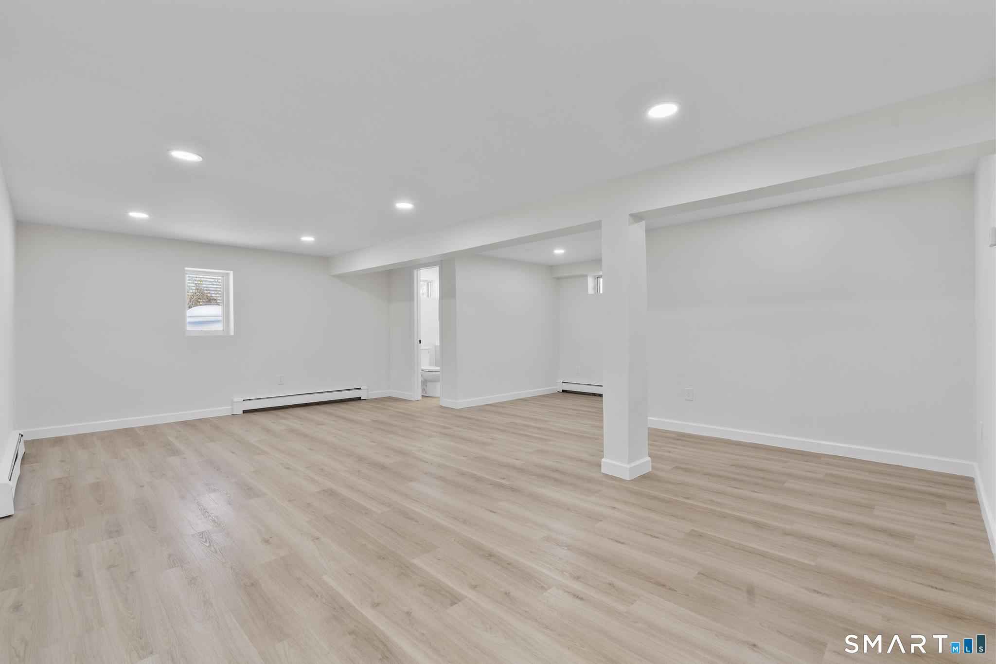 122 Lakeside Drive Ridgefield, CT 06877 - Photo 19 of 29 an empty room with wooden floor and window