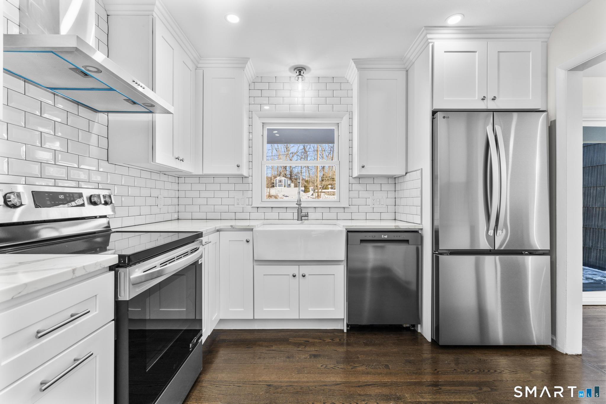 122 Lakeside Drive Ridgefield, CT 06877 - Photo 8 of 29 a kitchen with a refrigerator sink and cabinets