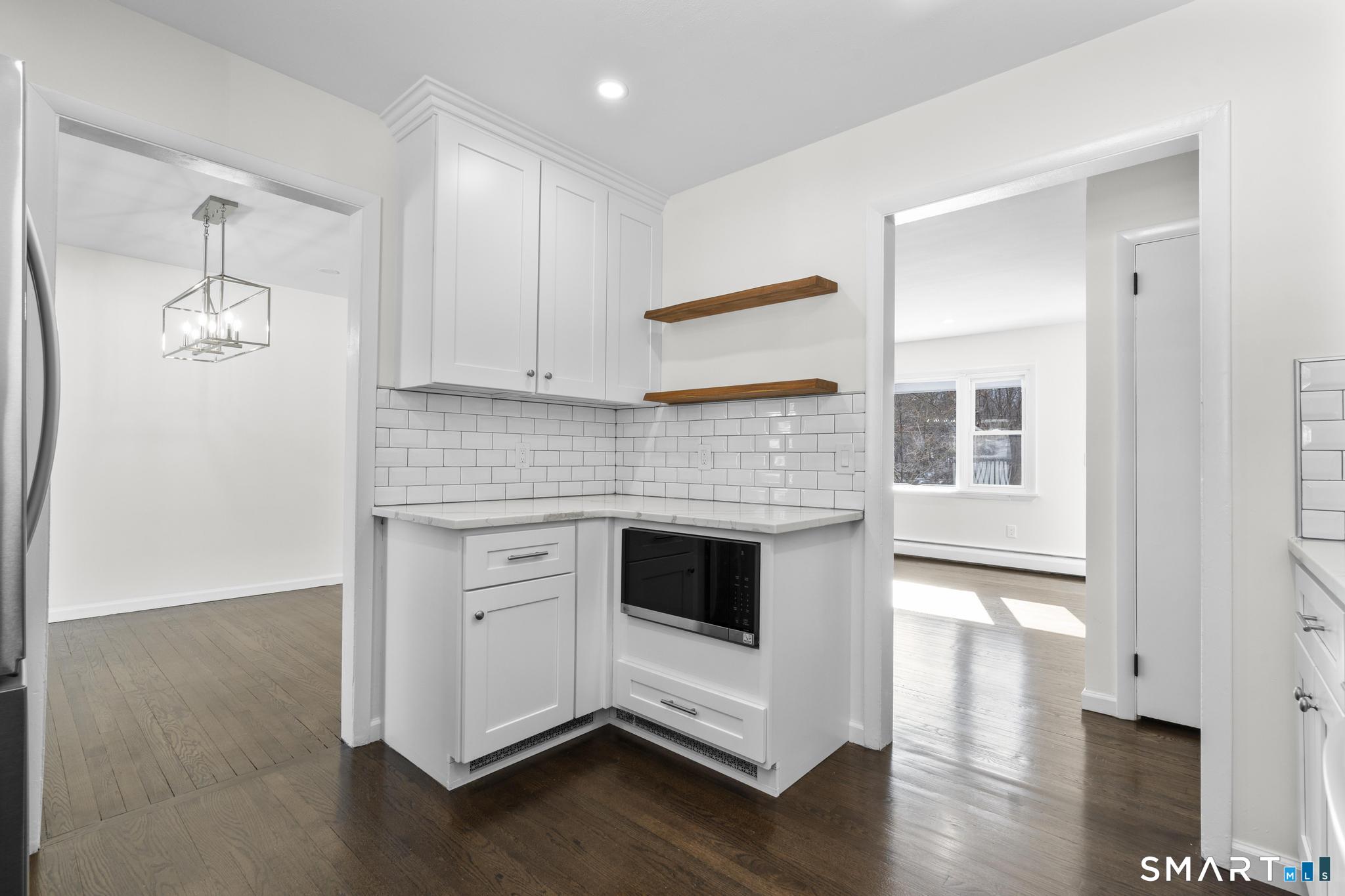122 Lakeside Drive Ridgefield, CT 06877 - Photo 10 of 29 a kitchen with stainless steel appliances a white stove top oven cabinets and a wooden floor