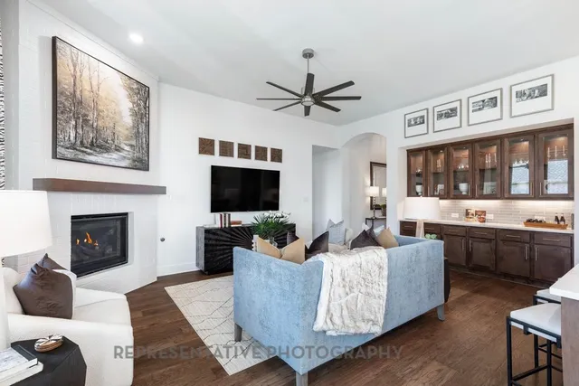 a living room with furniture a flat screen tv and a fireplace
