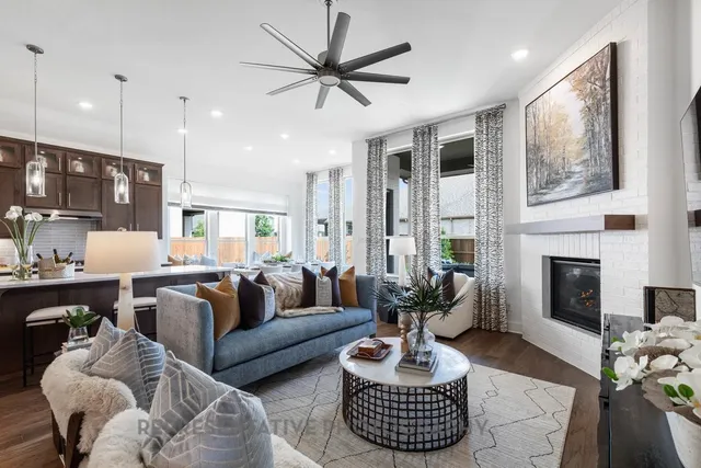 a living room with furniture fireplace and window