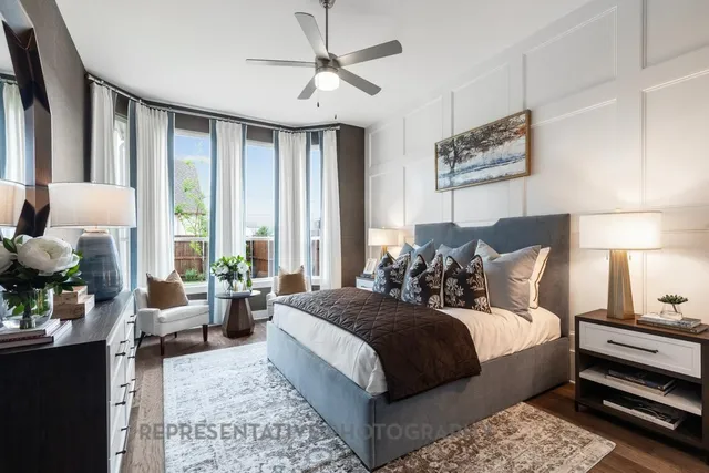 a large bedroom with bed and large window