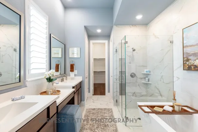 a spacious bathroom with a sink a shower and a mirror