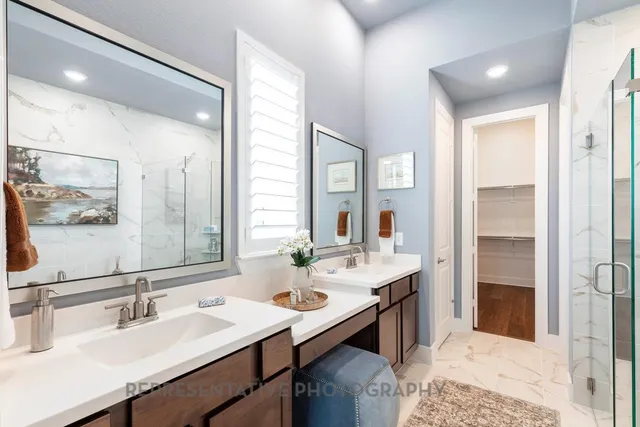 a bathroom with a sink double vanity and a mirror