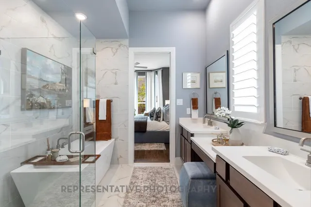 a en suite bathroom with a double vanity sink a large mirror and shower