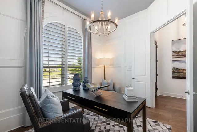 a living room with furniture a table and a large window