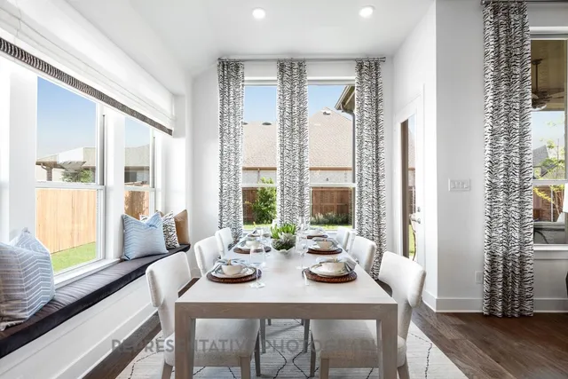 a kitchen with a dining table and chairs