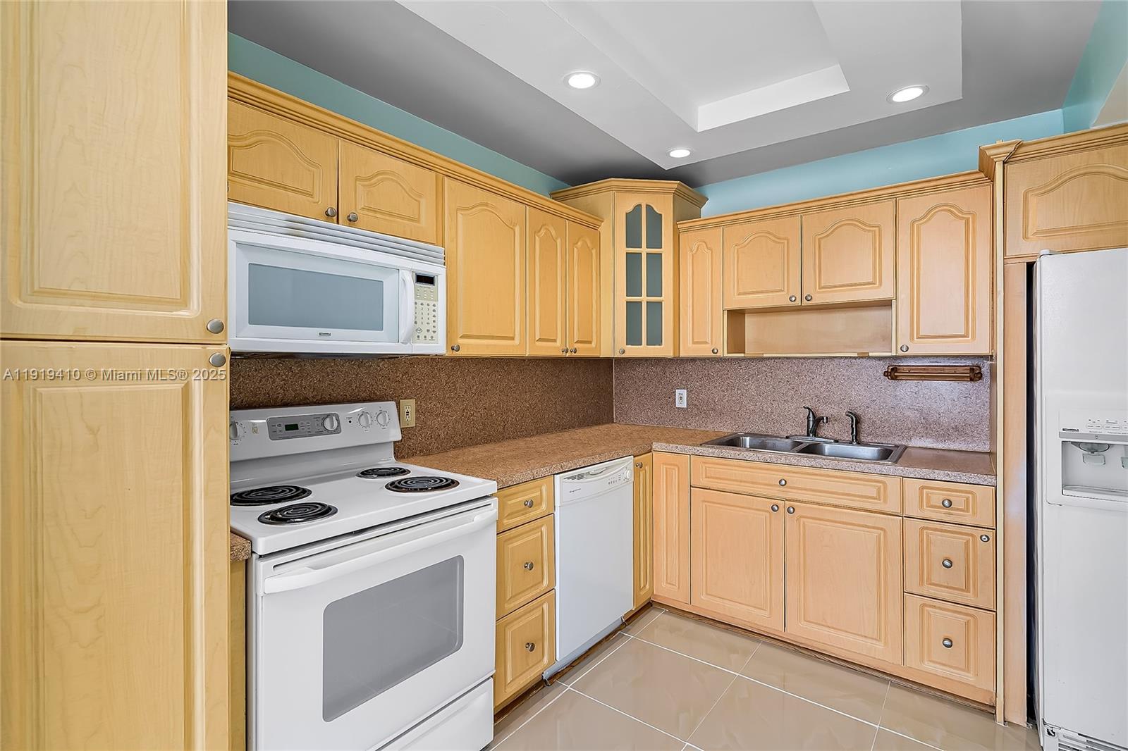 2025 Northeast 164th Street, Unit 907 North Miami Beach, FL 33162 - Photo 12 of 33 a kitchen with stainless steel appliances granite countertop a stove a sink and white cabinets