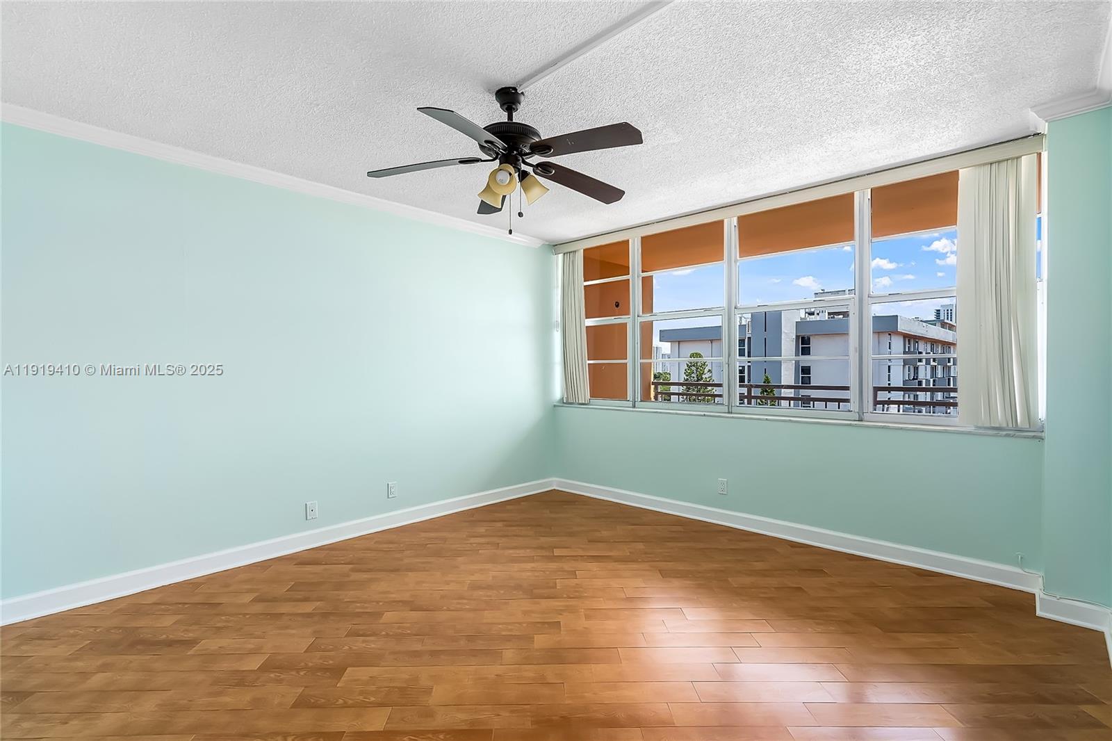 2025 Northeast 164th Street, Unit 907 North Miami Beach, FL 33162 - Photo 20 of 33 a view of a room with wooden floor and fan