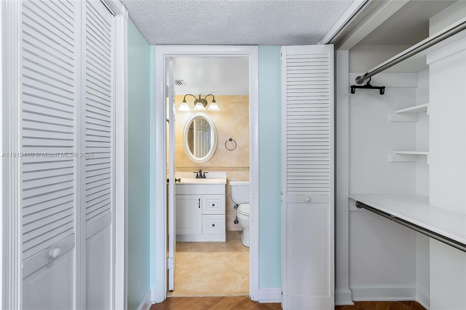 2025 Northeast 164th Street, Unit 907 North Miami Beach, FL 33162 - Photo 22 of 33 a bathroom with a granite countertop sink toilet and shower