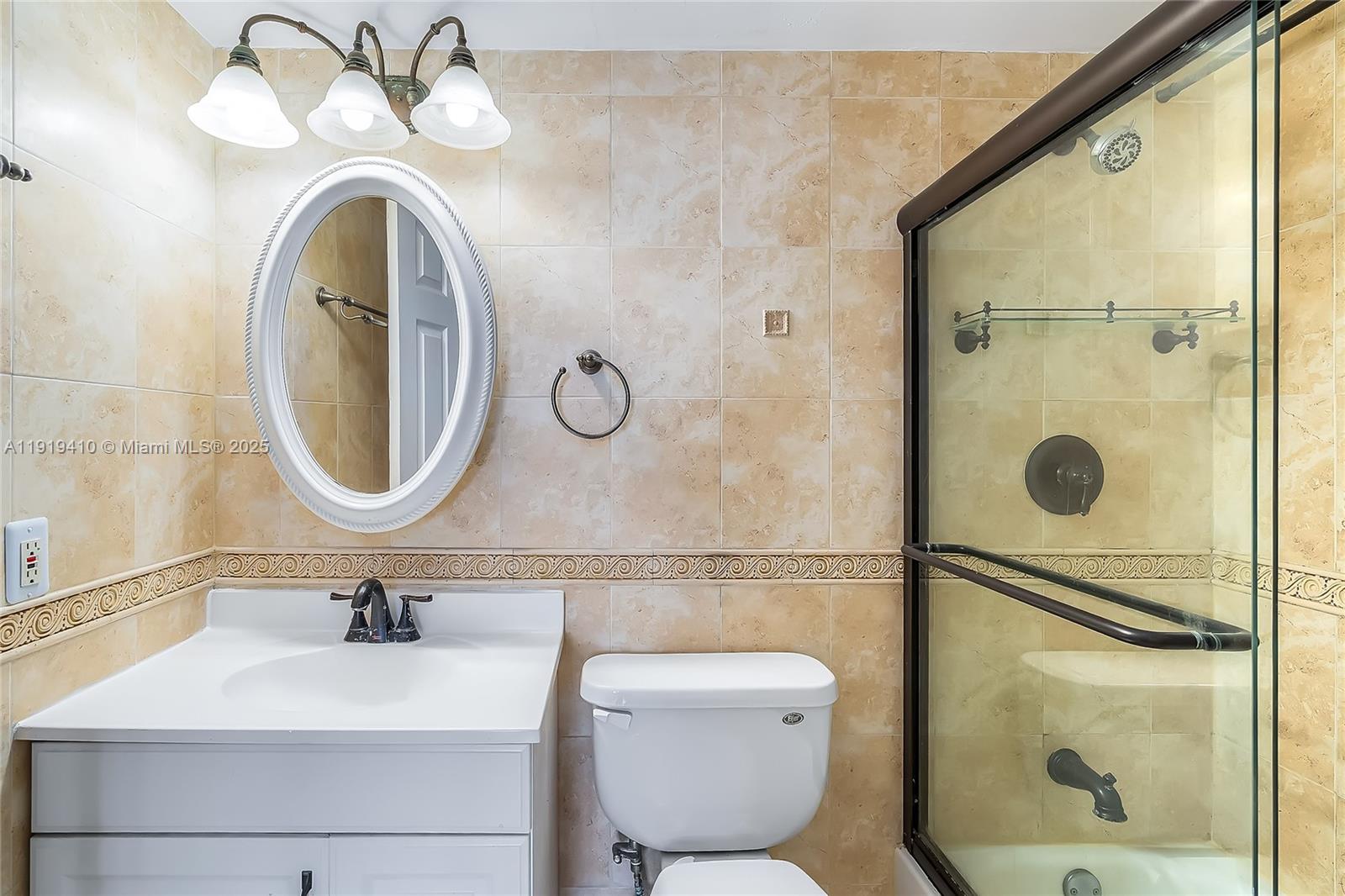 2025 Northeast 164th Street, Unit 907 North Miami Beach, FL 33162 - Photo 24 of 33 a bathroom with a sink mirror vanity and toilet