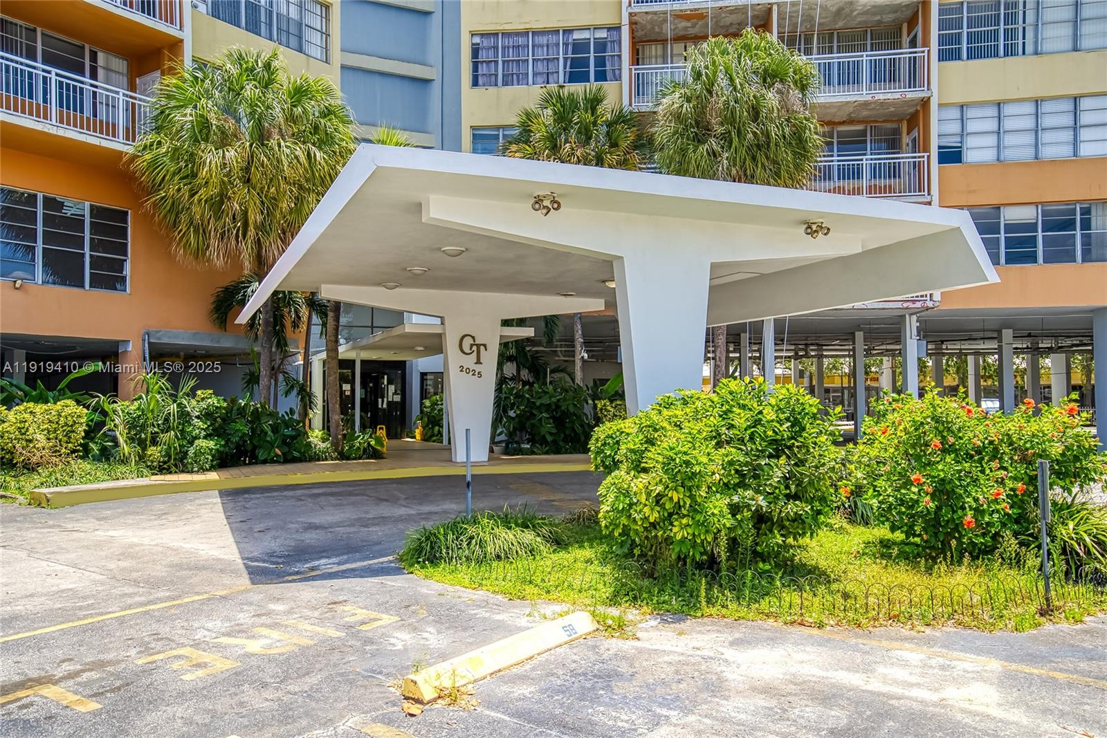 2025 Northeast 164th Street, Unit 907 North Miami Beach, FL 33162 - Photo 31 of 33 a view of a white house with a large windows and plants
