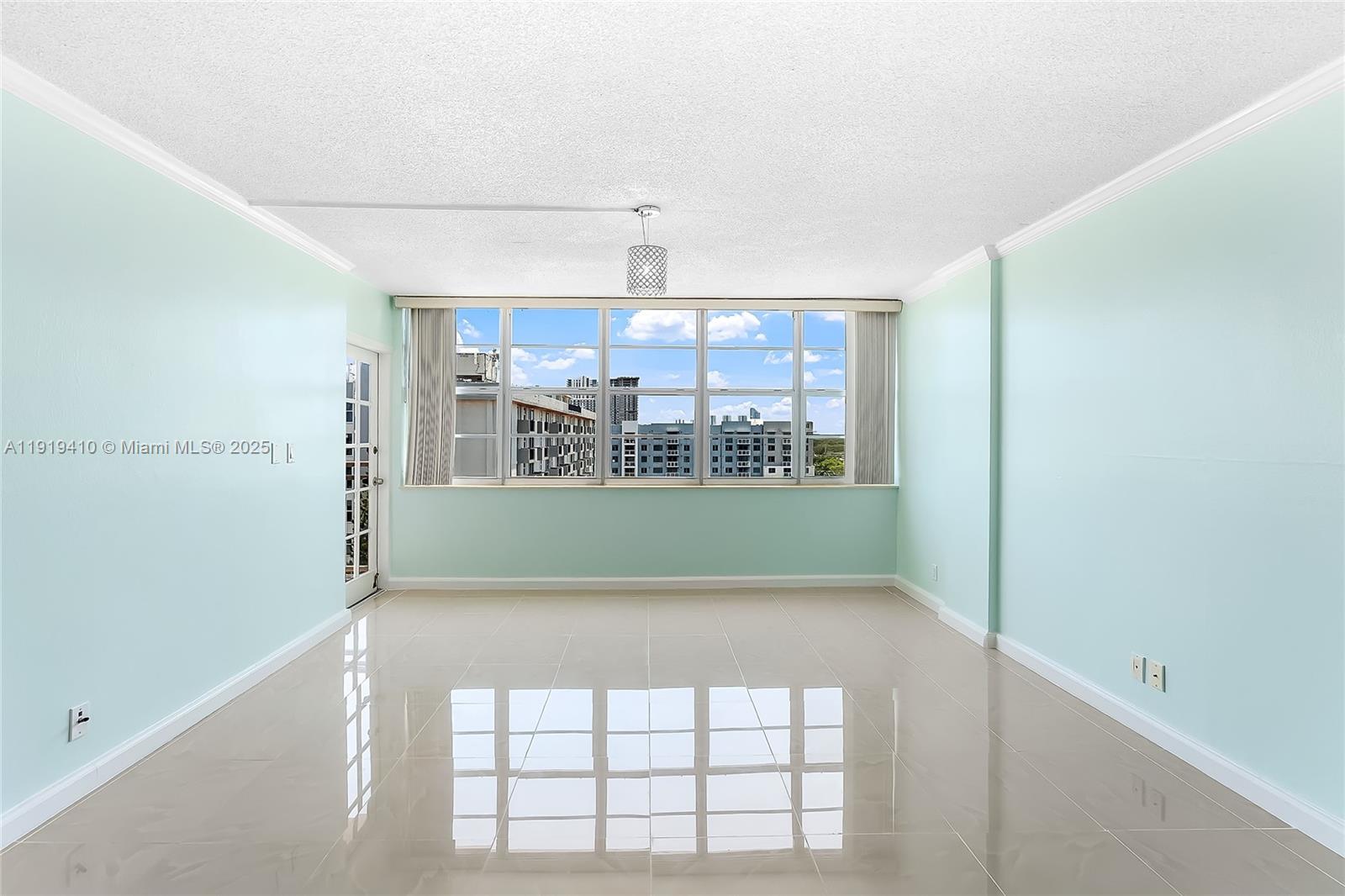 2025 Northeast 164th Street, Unit 907 North Miami Beach, FL 33162 - Photo 9 of 33 a view of a hallway with a window