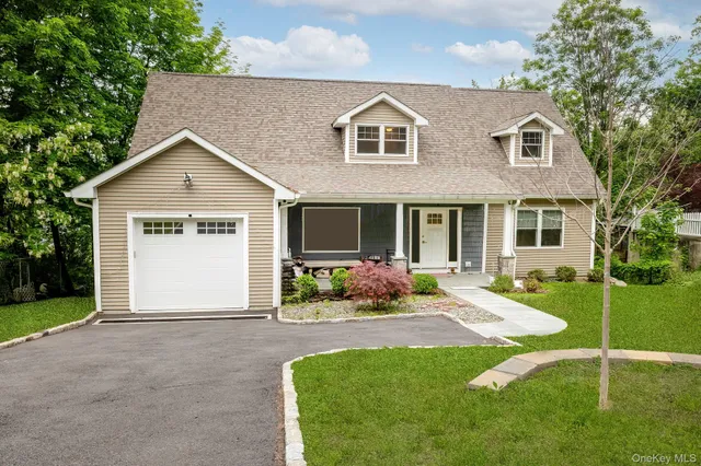 a front view of a house with yard and porch