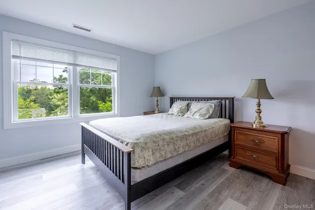 a bedroom with a bed and a large window