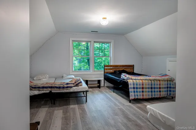 a bedroom with bed and a window