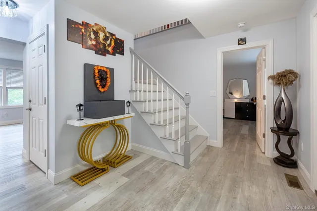 a view of a room with wooden floor and furniture