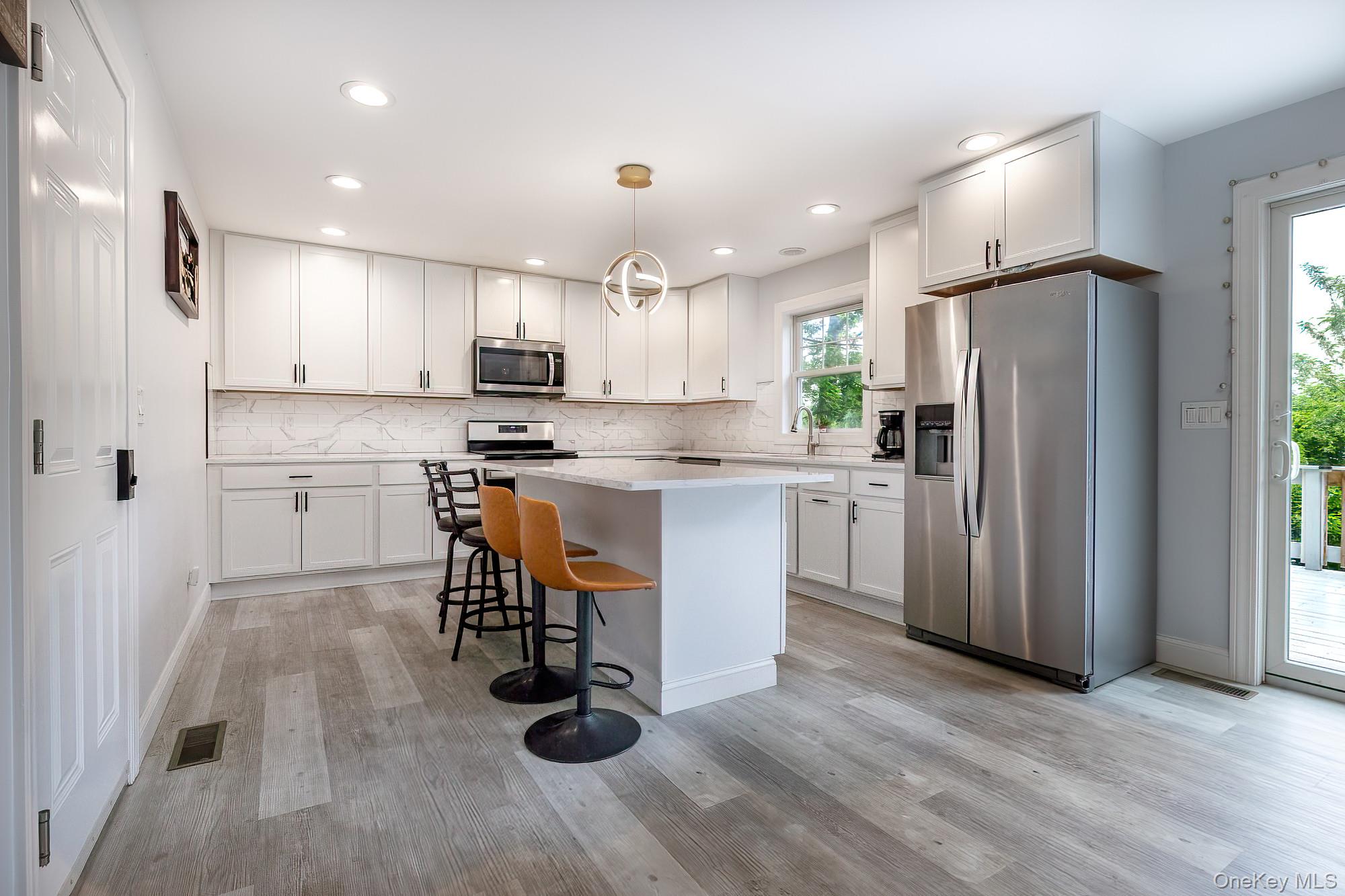 5 Teramar Way White Plains, NY 10607 - Photo 6 of 39 a kitchen with stainless steel appliances granite countertop a refrigerator a stove a sink dishwasher and a refrigerator with wooden floor