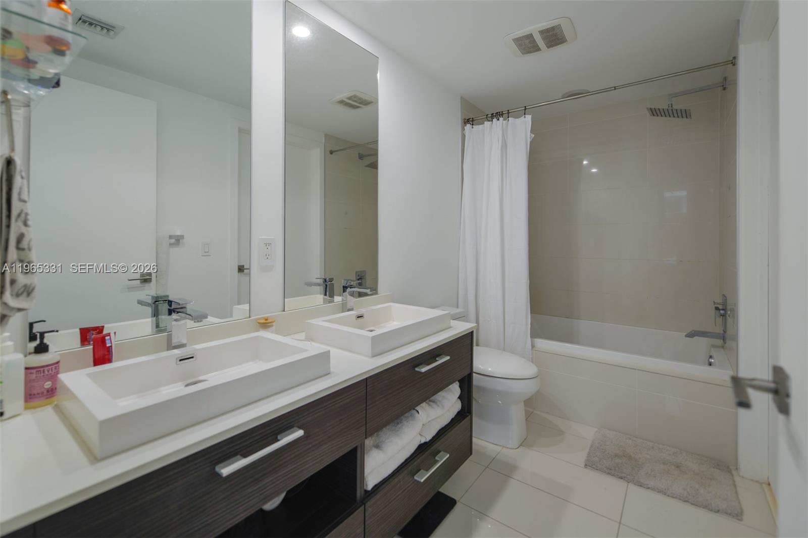45 Southwest 9th Street, Unit 1107 Miami, FL 33130 - Photo 13 of 50 a spacious bathroom with a double vanity sink toilet and shower