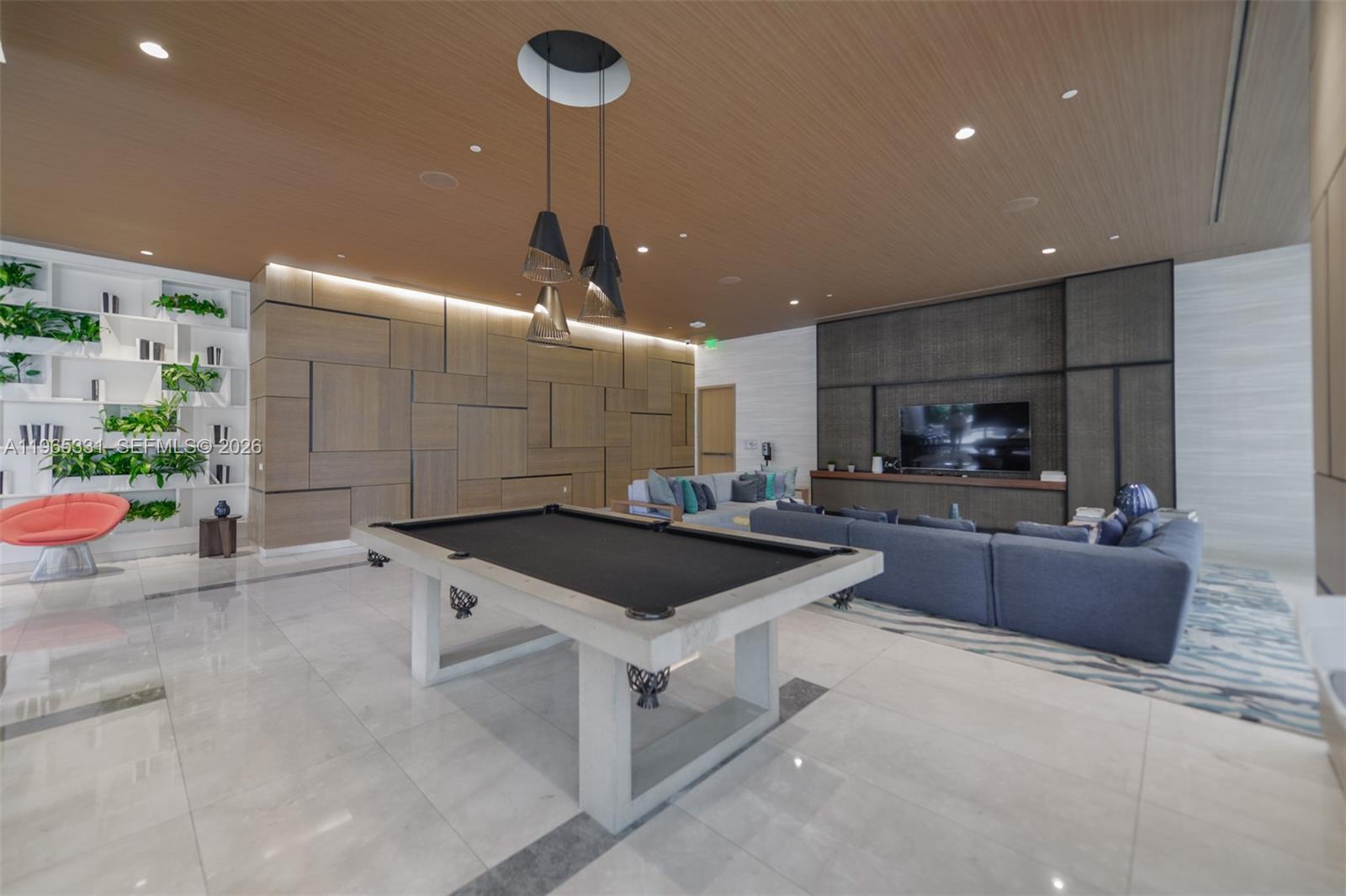 45 Southwest 9th Street, Unit 1107 Miami, FL 33130 - Photo 26 of 50 a kitchen with stainless steel appliances kitchen island granite countertop a sink and a stove
