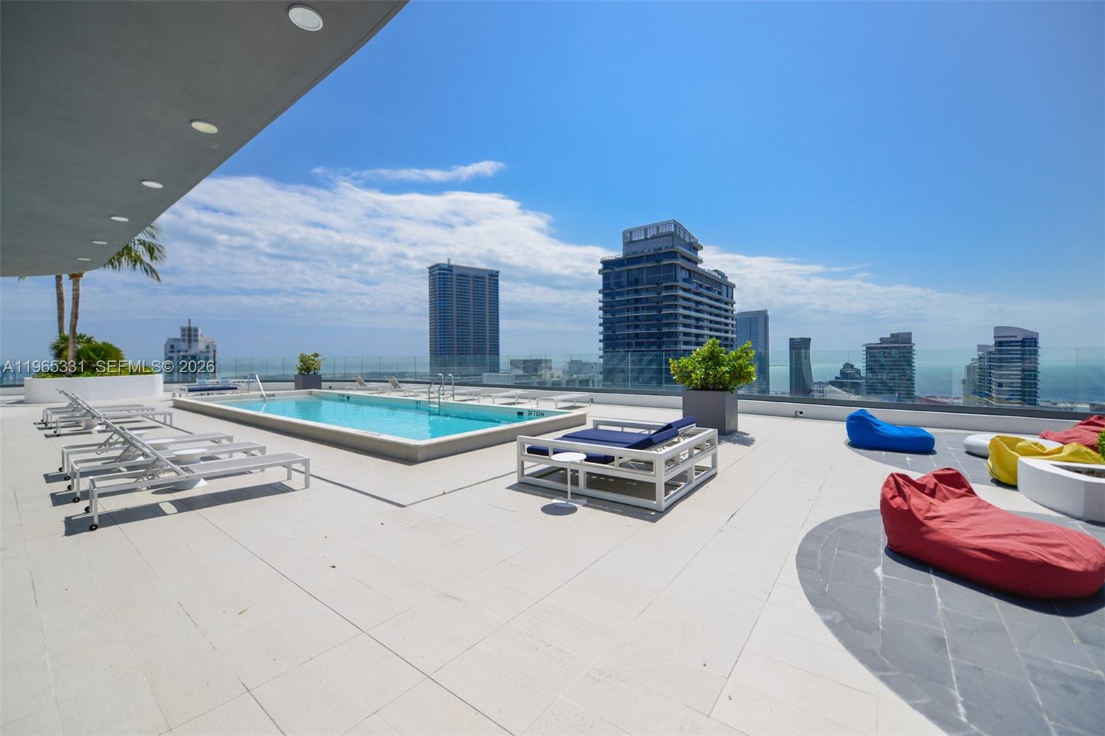 45 Southwest 9th Street, Unit 1107 Miami, FL 33130 - Photo 42 of 50 a swimming pool with outdoor seating and city view