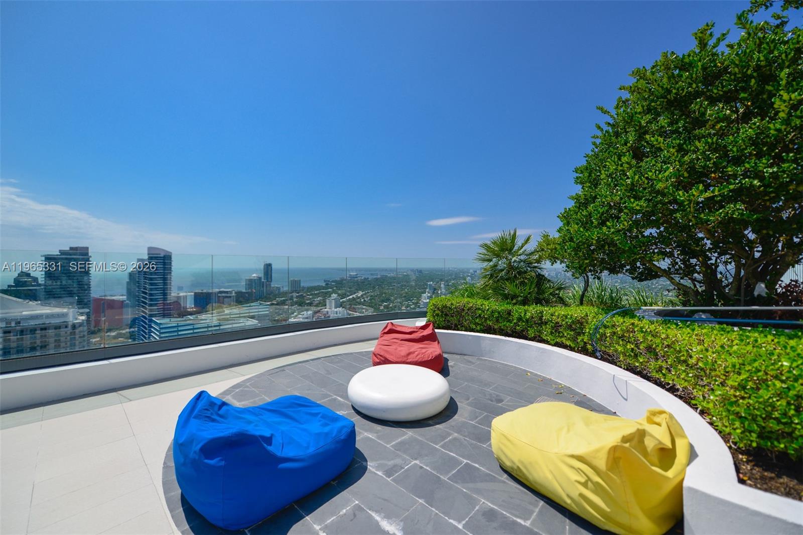 45 Southwest 9th Street, Unit 1107 Miami, FL 33130 - Photo 44 of 50 a view of a swimming pool with a chairs and plants
