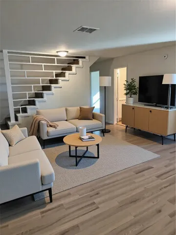 a living room with furniture and a flat screen tv