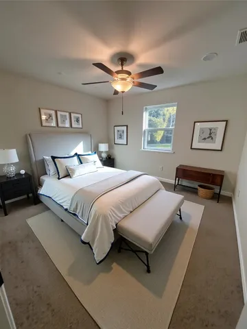 a bedroom with bed and a chandelier