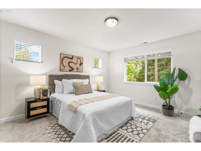 a bedroom with a bed plant and a window