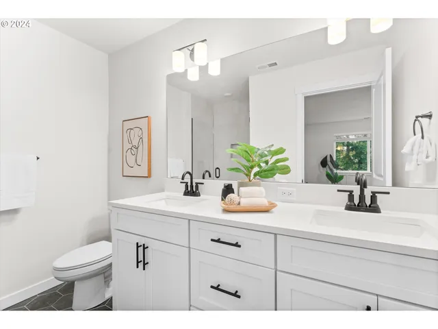 a bathroom with a sink a toilet and mirror