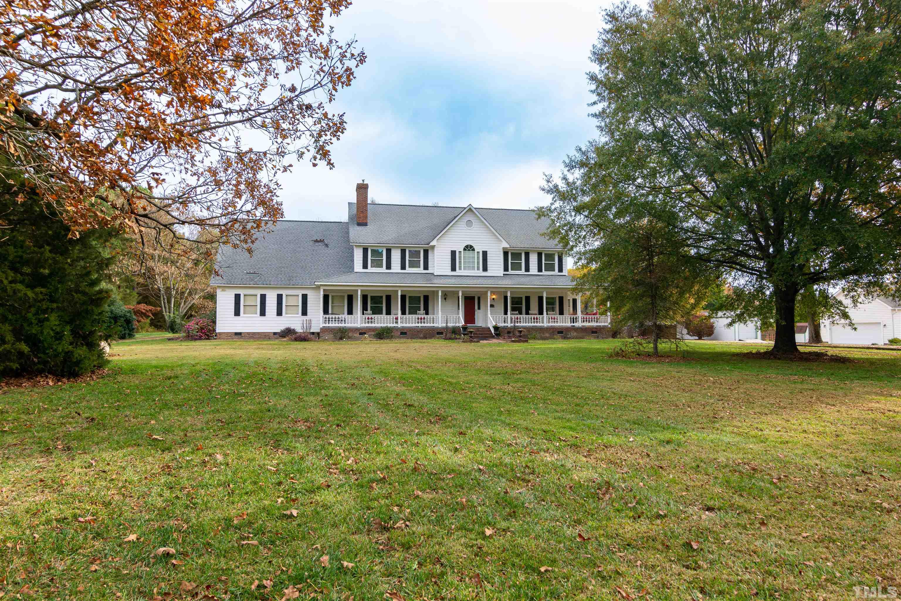 7020 Zebulon Road Wake Forest, NC 27587 - Photo 1 of 45 a front view of a house with a garden
