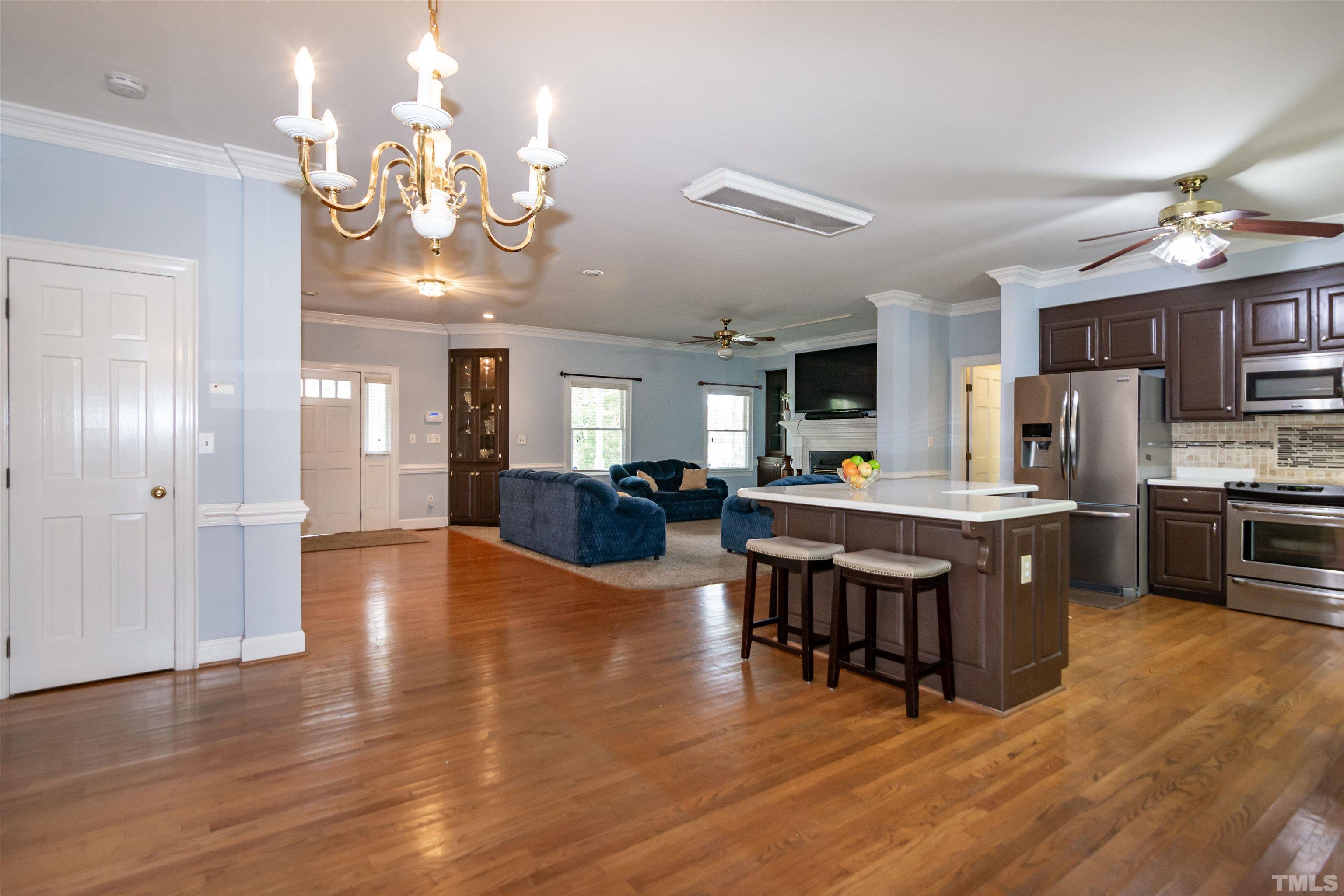 7020 Zebulon Road Wake Forest, NC 27587 - Photo 14 of 45 a large kitchen with a table and stainless steel appliances